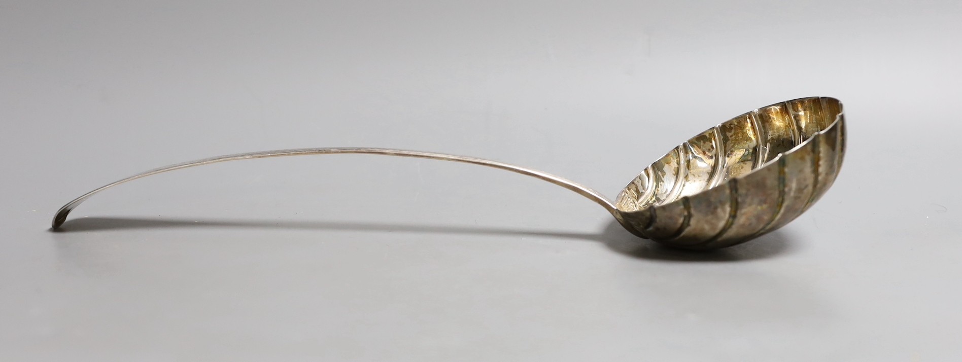 A George IV Irish engraved silver soup ladle, with fluted bowl, Charles Marsh, Dublin, 1826, 34.6cm, 187 grams.
